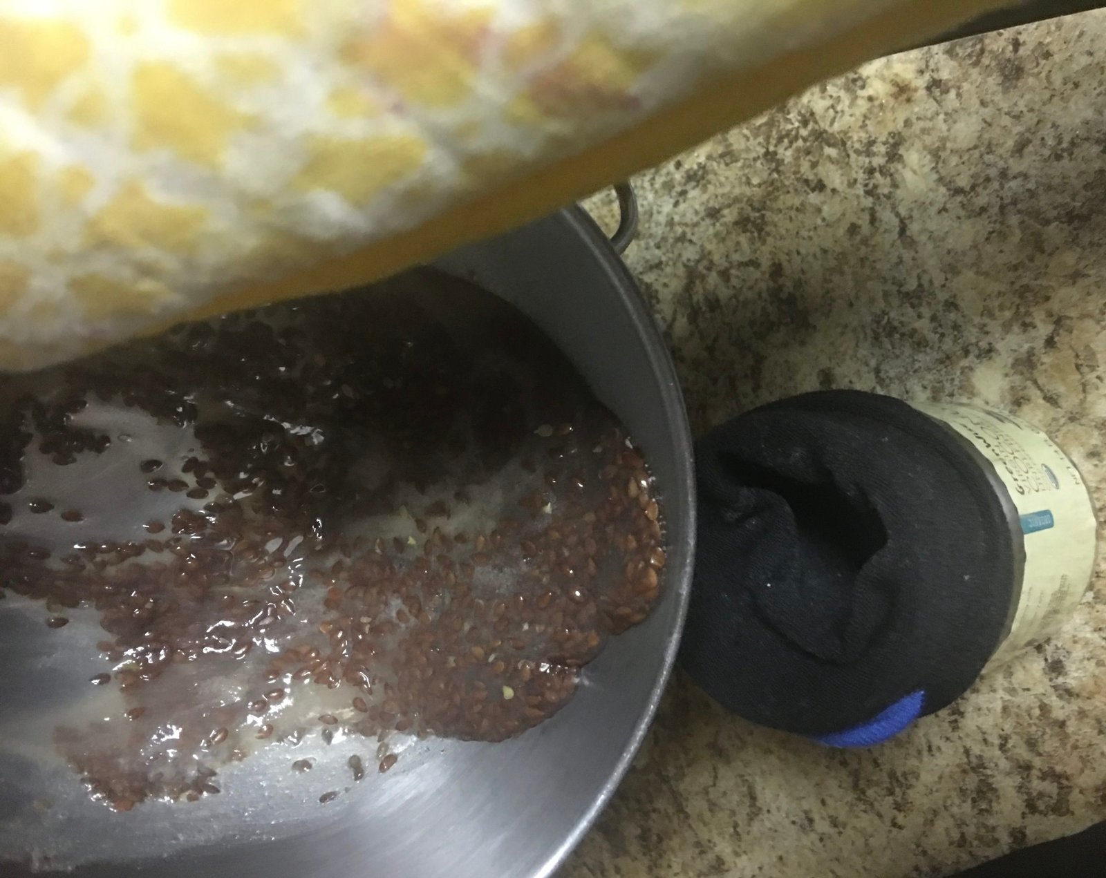 Homemade flaxseed gel being poured into jar.